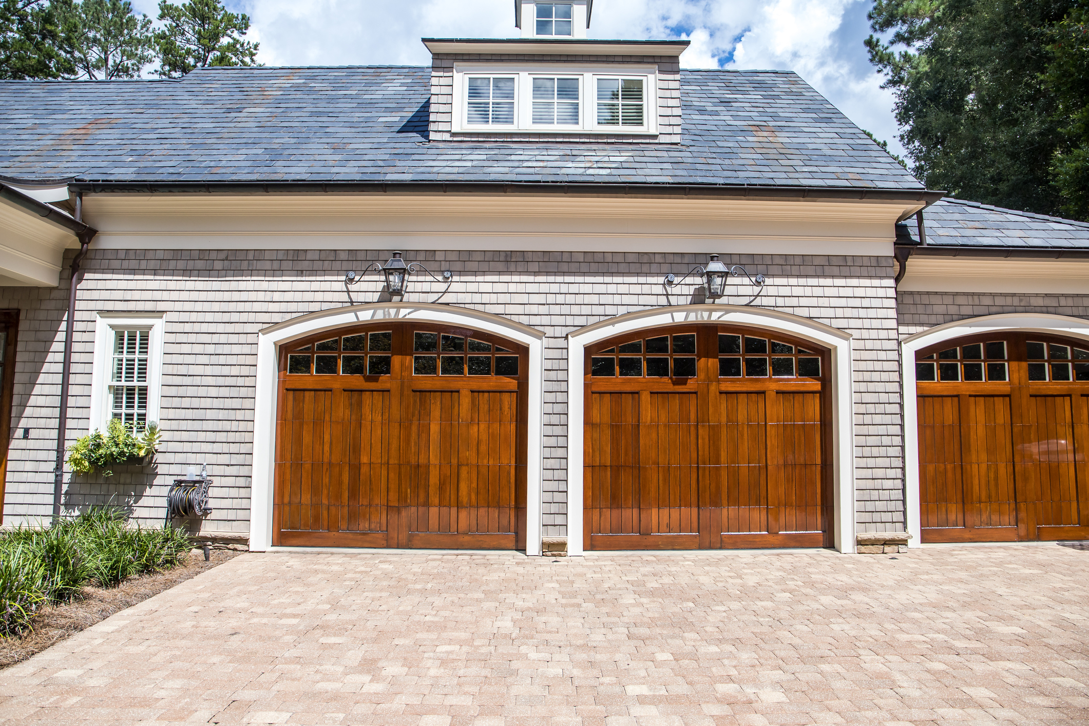 Stained wood custom garage doors for large southern home